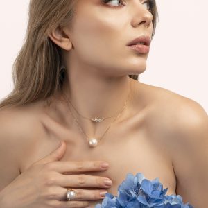 a woman holding a blue flower