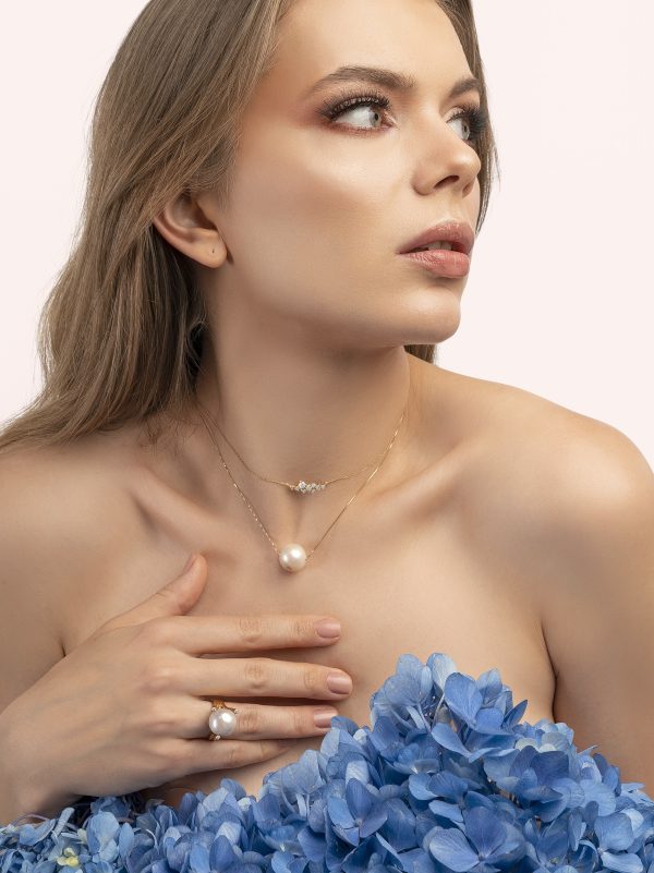 a woman holding a blue flower